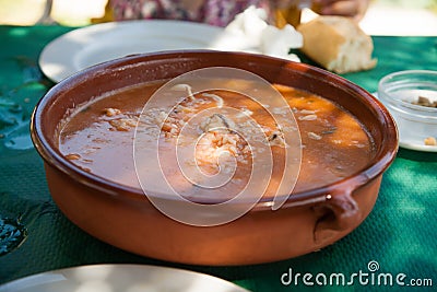 Crockpot with soup rice with fish and prawns Stock Photo