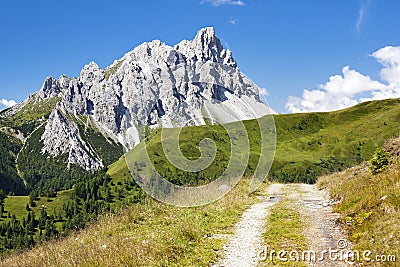 Crode Dei Longerin with rural road - Alpi Carniche Stock Photo