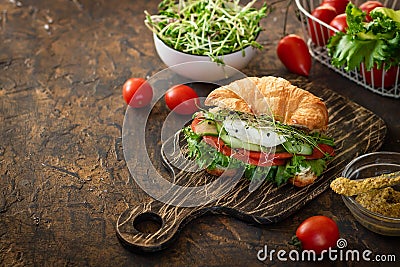Croissant fish and poached egg sandwich Stock Photo