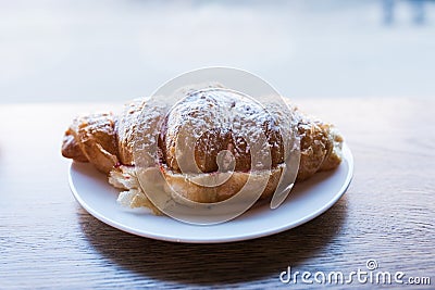 Croissant sandwich sprinkled with powdered sugar. Fast snack food Stock Photo