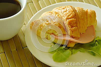 croissant stuffed pork bologna and green oak with black coffee Stock Photo