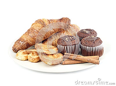 Croissants, muffins, cookies and stiks cinnamon of plate Stock Photo