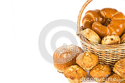 Croissants, muffins and other sweet pastries in a wicker basket isolated on white . Free space for text Stock Photo