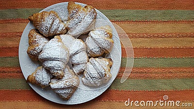 Croissants in a plate on a strips fabric surface Stock Photo