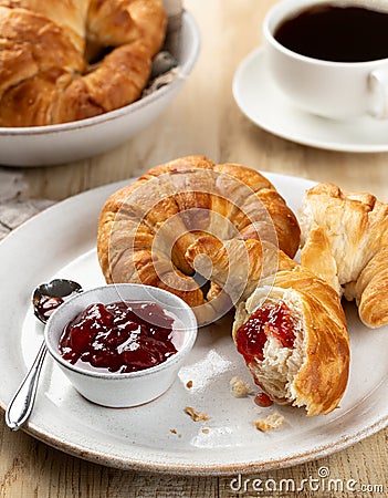 Croissants with strawberry preserves and cup of coffee Stock Photo