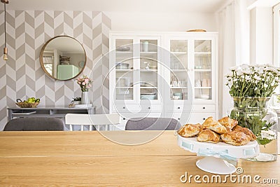 Croissants on wooden dining table in white apartment interior wi Stock Photo