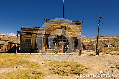 Crooked abandoned western saloon building and shop in Bodie Ghost Town Stock Photo