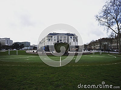 Crooked circular curved football soccer pitch field green grass meadow ground mirror reflection in Feydeau Nantes France Stock Photo