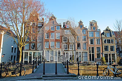 Crooked and colorful heritage buildings, with the bridge Mekmeisjesbrug in the foreground and located along Brouwersgracht Canal, Stock Photo