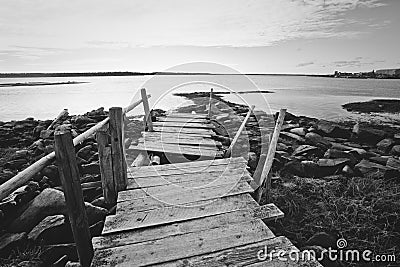 Crooked old wooden dock on the rocky shore. Russia, Karelia Stock Photo
