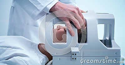 Crop doctor preparing boy for MRI procedure in lab Stock Photo