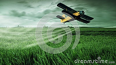 A crop dusting plane working over a field Stock Photo