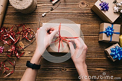 Crop hands decorating present Stock Photo