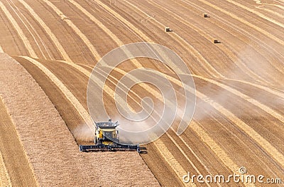Crop havesting with a combine on a dry sunny day Stock Photo