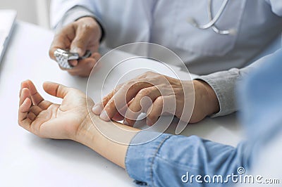 Crop image of doctor take the pulse of patient Stock Photo