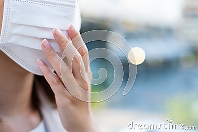 Crop image of young woman wearing surgical mask Stock Photo