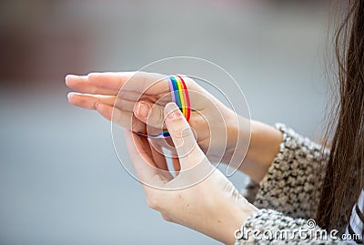 Crop person with LGBT bracelet Stock Photo