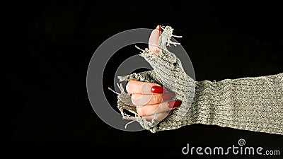 Crop person showing thumbs up. Hand of anonymous person showing thumbs up on black background Stock Photo