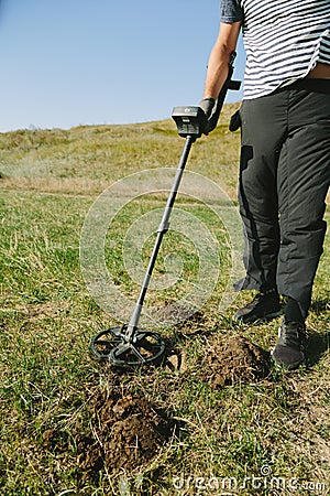 Person with metal finder on nature Stock Photo