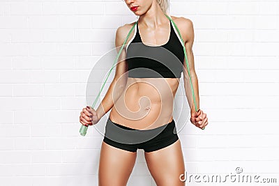 Crop photo of Fit woman isolated on white background with a jump rope over her shoulders. Copy space Stock Photo