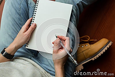 Crop woman with blank notepad. From above of crop casual girl in denim Stock Photo