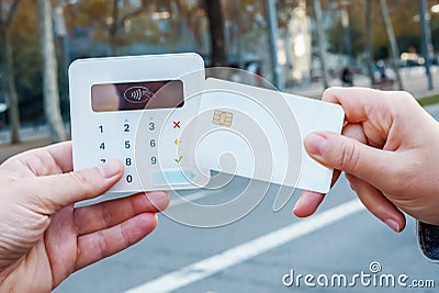 Crop woman making NFC payment in city Stock Photo