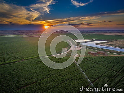 Cropland and holding pond at sunset Stock Photo