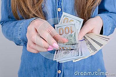 Cropped close-up photo of girlish beautiful hands with long nails pink bright manicure on fingers holding calculating old money Stock Photo