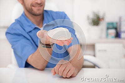 Plastic surgeon showing breast implants to a patient Stock Photo