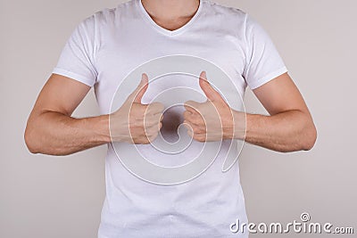 Cropped close up studio photo portrait of delightful happy nice handsome guy demonstrating two fingers up with hands isolated on g Stock Photo