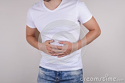 Cropped close up studio photo portrait of upset sad scared worried troubled gut having stomach ache disorder wear denim pants isol Stock Photo