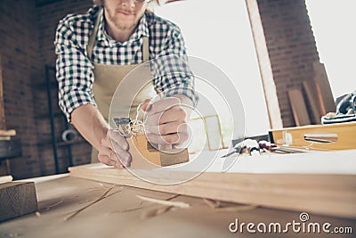 Cropped close-up view of his he nice attractive handsome guy skilled artisan builder polishing long board making new Stock Photo