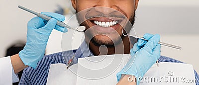 Cropped of dentist hands with tools and smiling man patient Stock Photo