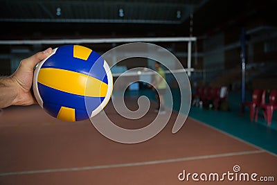 Cropped hand of sportsperson holding volleyball Stock Photo