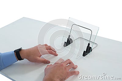 Cropped hands of businessman typing on imaginary keyboard while using glass interface Stock Photo