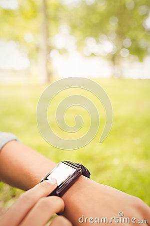 Cropped hands touching smart watch Stock Photo