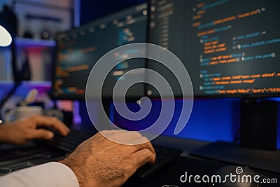 Cropped hands typing on keyboard of IT developer& x27;s on pc. Surmise. Stock Photo