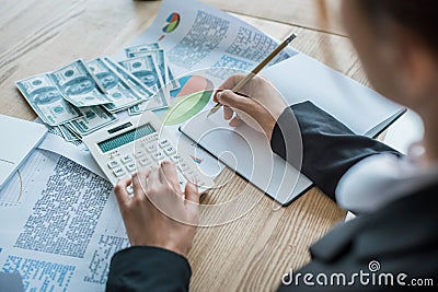 cropped image of accountant writing something to notebook Stock Photo