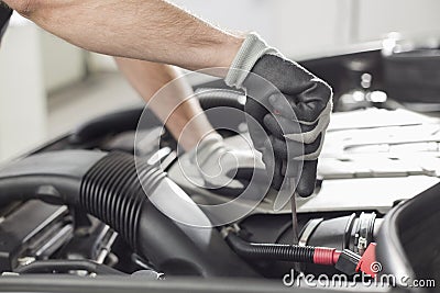 Cropped image of automobile mechanic repairing car in automobile store Stock Photo