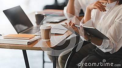 Cropped image of business developer team discussing/planning/meeting by using a computer tablet . Stock Photo