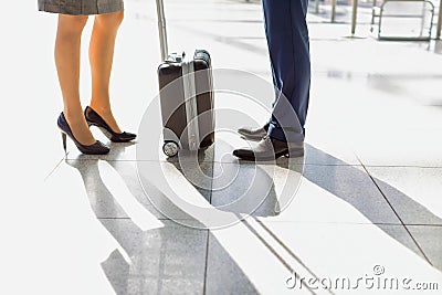 Cropped image of businessman and businesswoman standing in airport Stock Photo