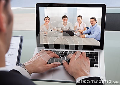 Cropped image of businessman using laptop at desk Stock Photo