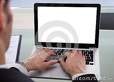 Cropped image of businessman using laptop at desk Stock Photo