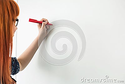 Cropped image of businesswomen writing on whiteboard in creative office Stock Photo