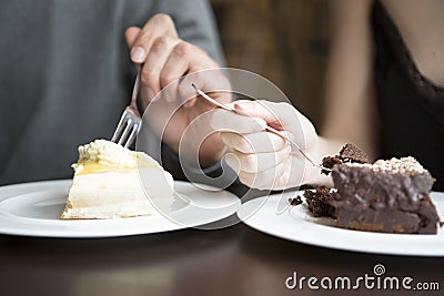 Cropped image of couple having pastries Stock Photo