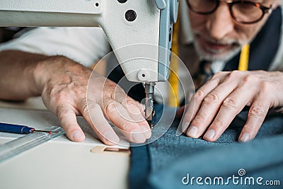 cropped image of dressmaker sewing cloth with sewing machine Stock Photo