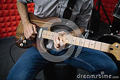Cropped image of electric guitar player in soundproof studio Stock Photo