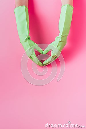 cropped image of female cleaner in rubber gloves making heart symbol by hands pink Stock Photo