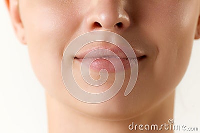 Cropped image of female face, lips and nose over white background. Lip augmentation and anti-wrinkle fillers Stock Photo