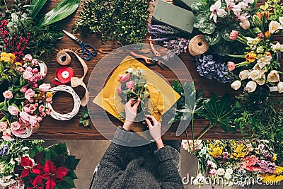 cropped image of female florist wrapping bouquet Stock Photo